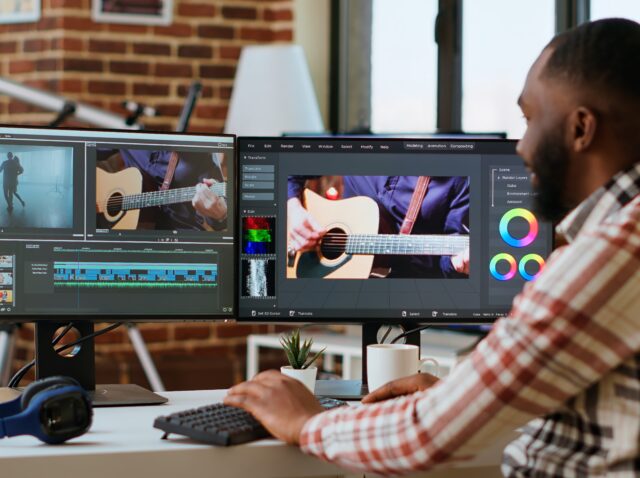 African american freelancer editing a background video at his home office